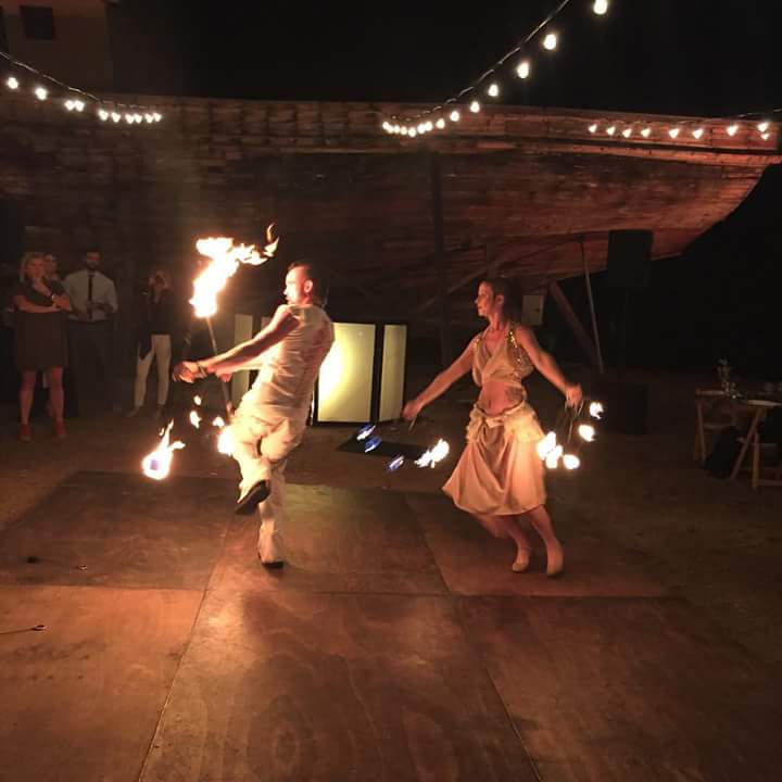 performing their fire dance duet for a private wedding in wine country Mexico wedding entertainment fire show