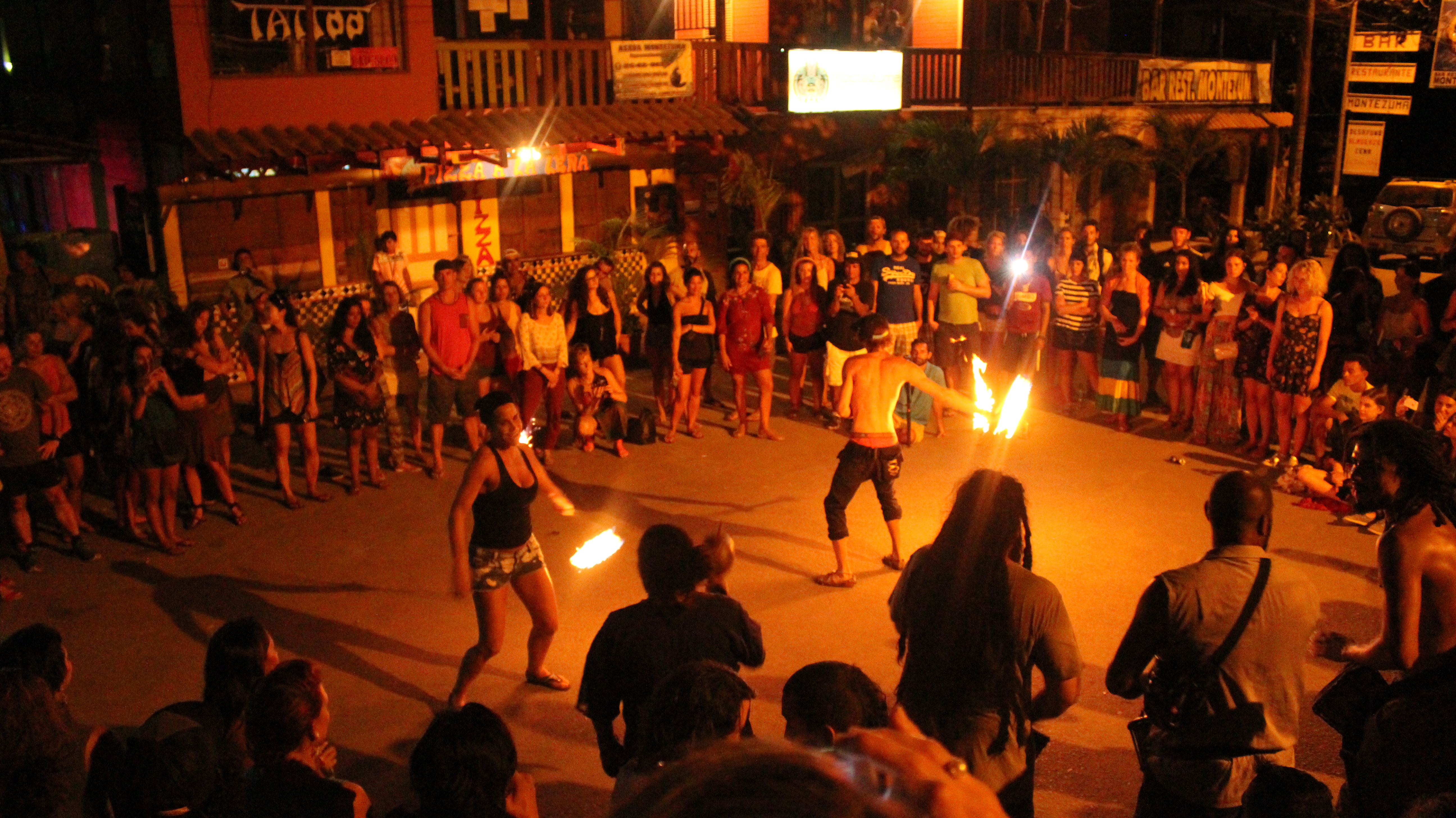 Costa Rica Fire Dance Retreat students Tricia Russel and Keegan Agnew show off their new skills in the local fire circle in front of Chico Bar Montezuma Costa Rica flow retreat tropical